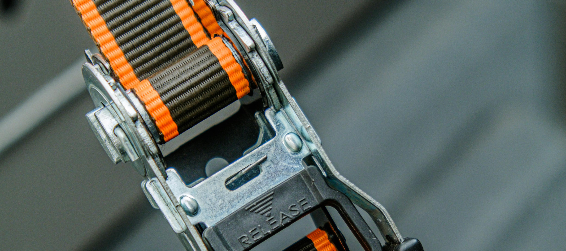 A close up of a ratchet strap.