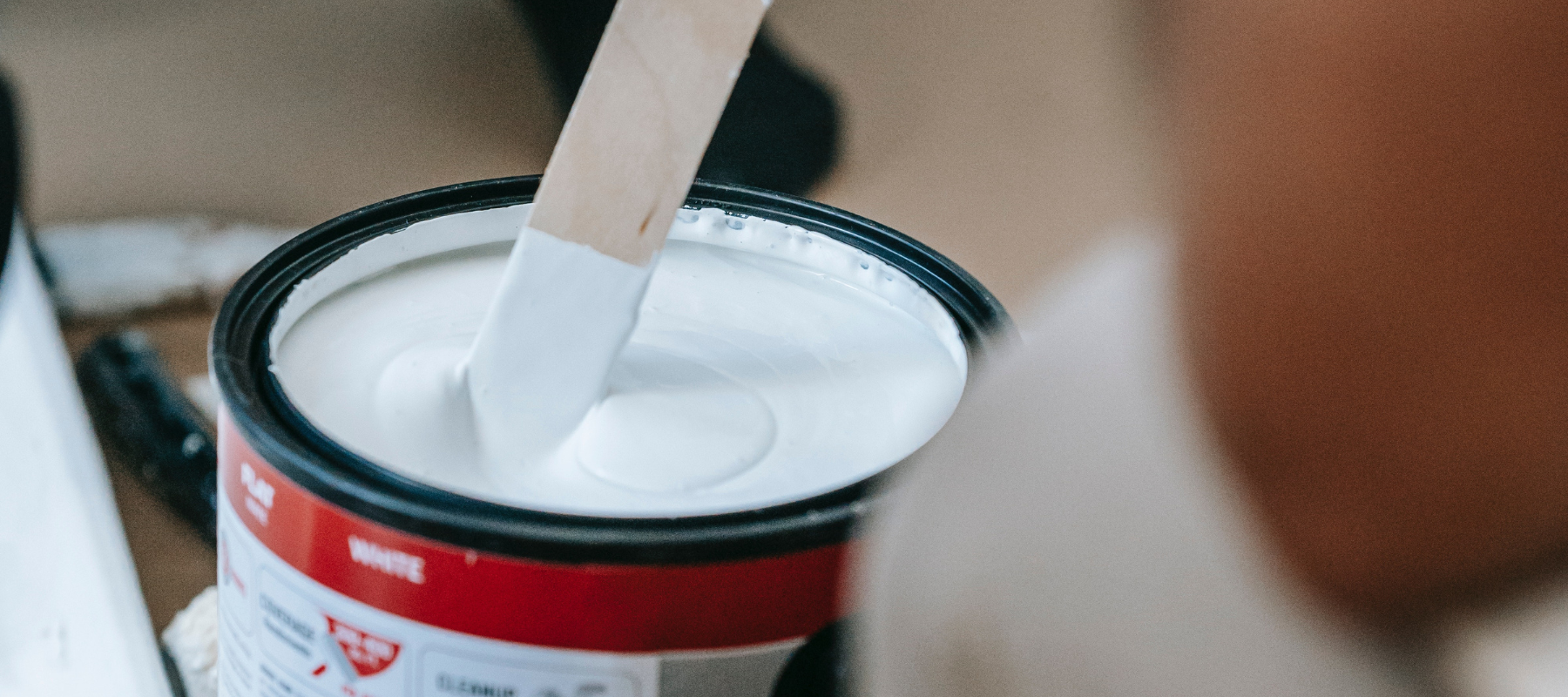 Paint cans, rollers, and supplies for home improvement projects.