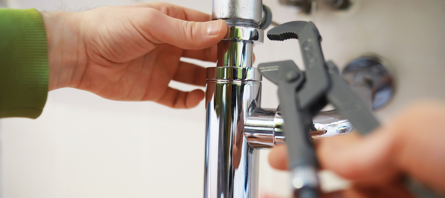 Pipe being tightened by a wrench
