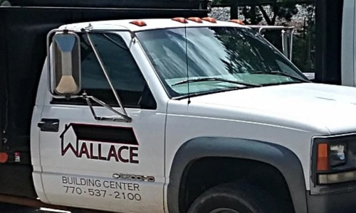 Wallace Building Center delivery truck bringing building materials to a job site.