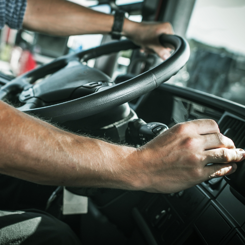 Hands on a steering wheel.