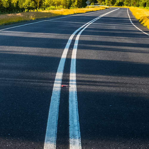 A close-up of a black top road.