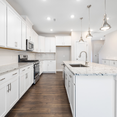 A kitchen with white cabinets