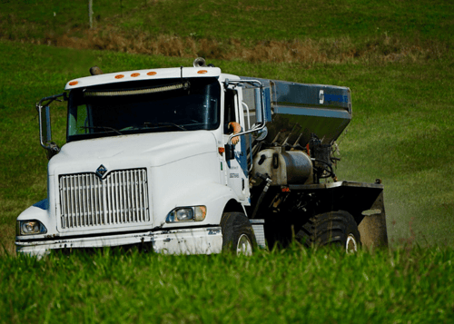 Fertilizer spreading truck in a field — fertilizer spreading service.