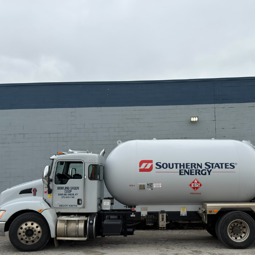 A propane delivery truck with "Southern States Energy" logo is parked against a gray brick wall. The sky is overcast, creating a muted, overcast atmosphere.