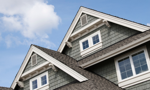 A metal and shingle roof combination showcasing roofing materials available in store.