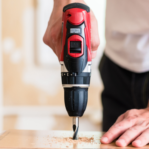 Red power drill being used